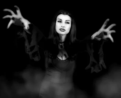 A black-and-white image shows actress Anna Paquin in six sequential frames, portraying a vampire-like character with long…