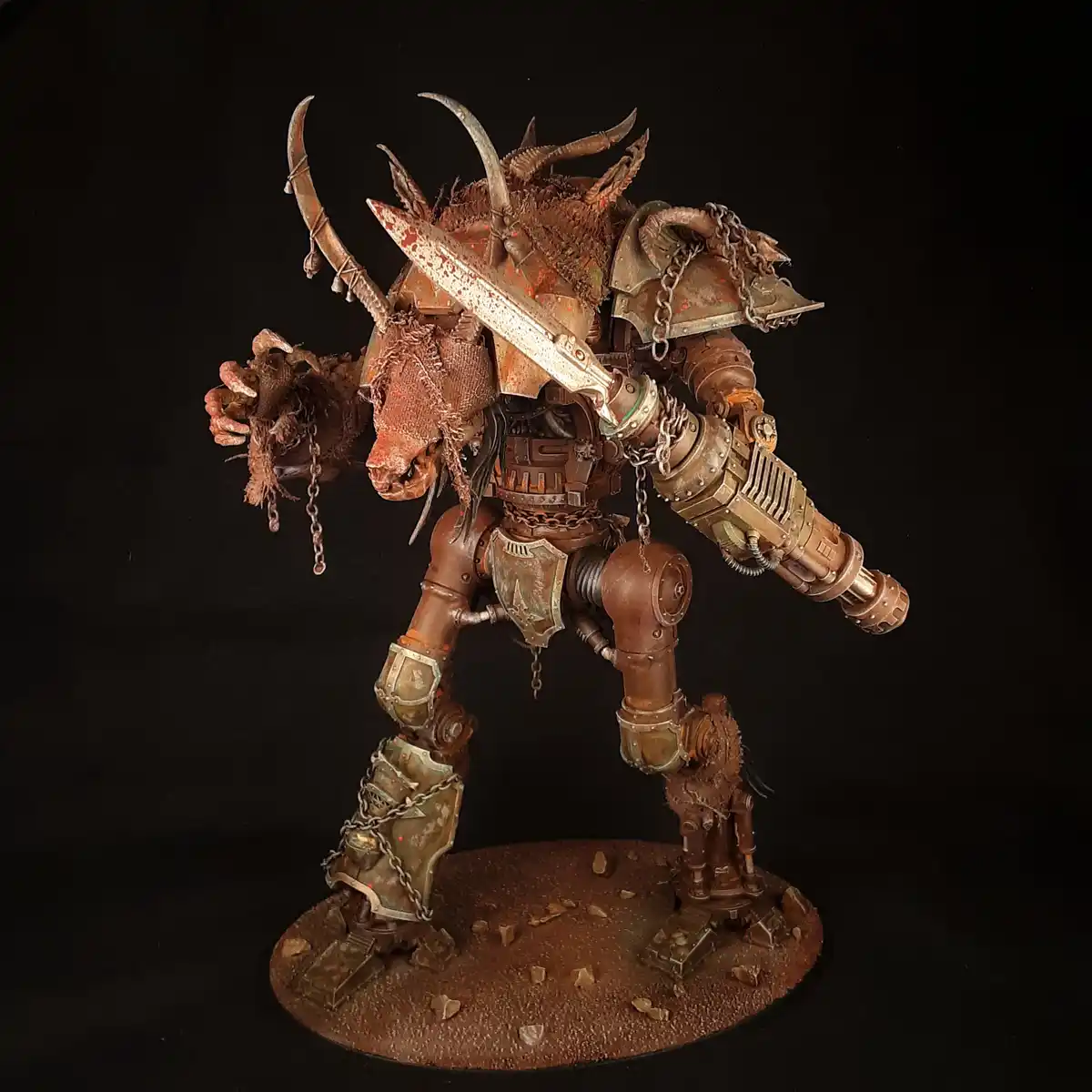 A heavily weathered and rusted miniature of a biomechanical, horned warrior with a bull-like head, wielding a large sword…