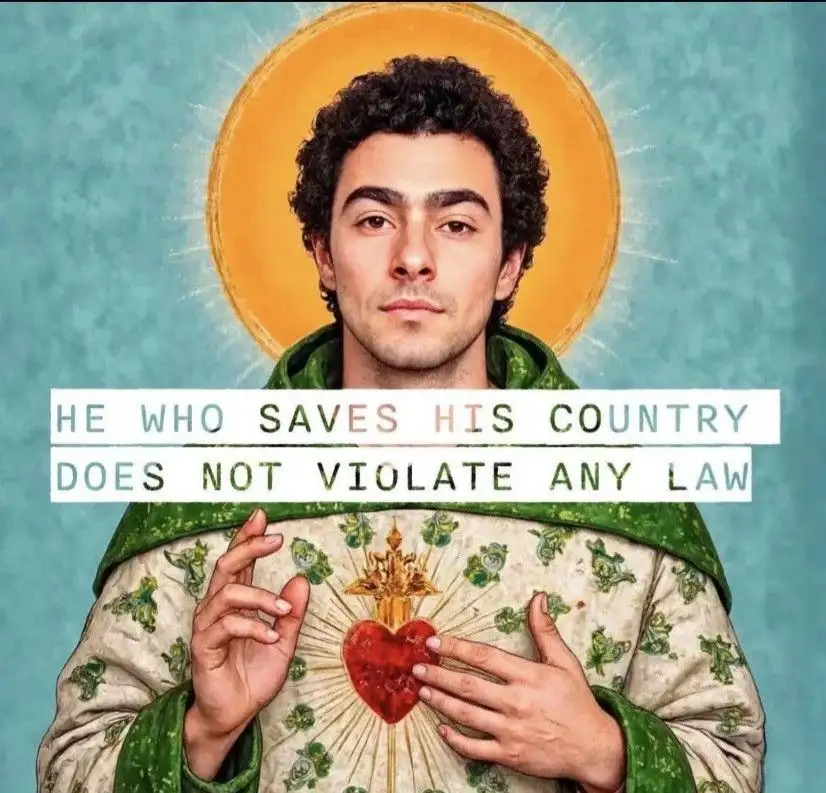 A man with curly dark hair and a calm expression is depicted in a saintly style, wearing a green robe over a white garment…