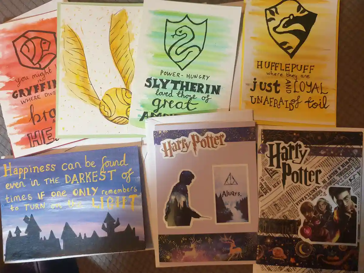 A collection of handmade Harry Potter-themed cards featuring Hogwarts house crests and quotes. Visible cards include…