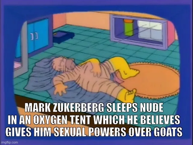 A cartoon image shows a man sleeping nude on a rug in a room with a blue cabinet and a window. The overlaid text reads…