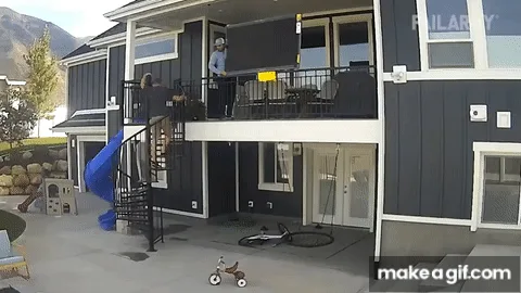 A sequence of images shows a man on a spiral staircase attempting to retrieve a skateboard from a lower level of a modern…