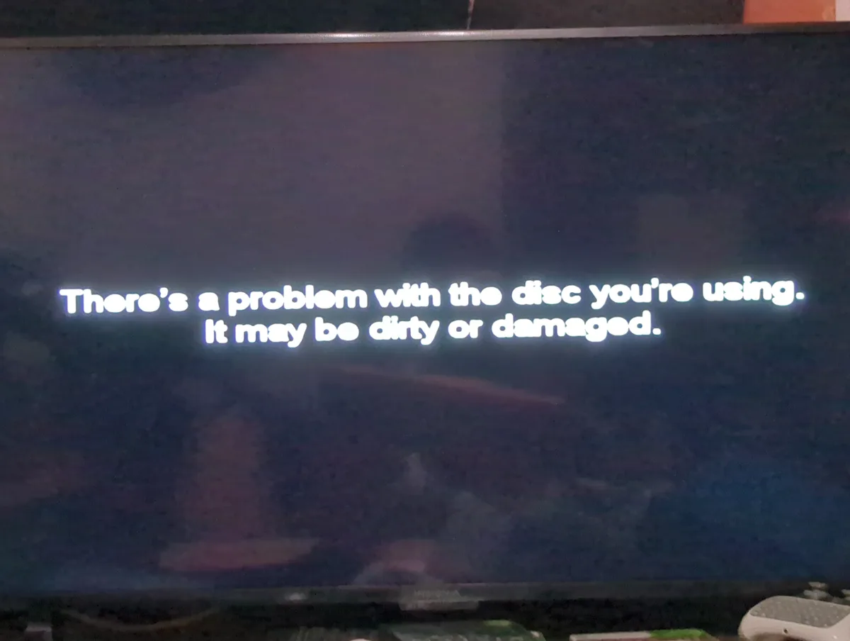 A close-up photo of a TV screen displaying a standard error message in white text against a dark background. The message…