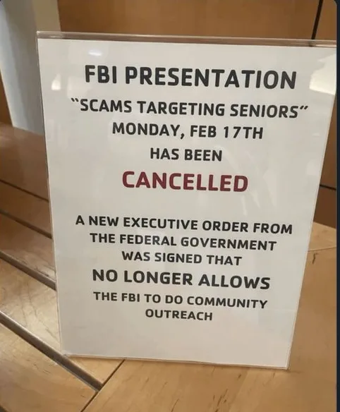 A white sign on a wooden surface announces the cancellation of an 'FBI Presentation' about scams targeting seniors scheduled…