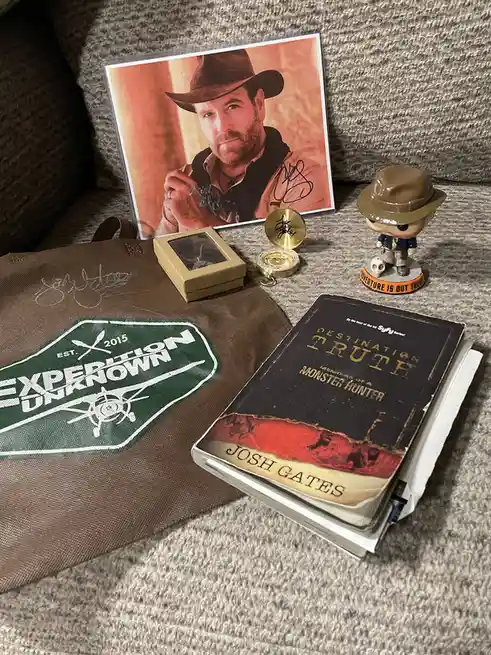 A collection of Josh Gates memorabilia, including his signed photo, a signed 'Expedition Unknown' tote bag, a signed…