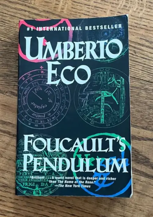 A book cover for 'Folicault's Pendulum' by Umberto Eco, featuring a dark background with circular diagrams and the author's…