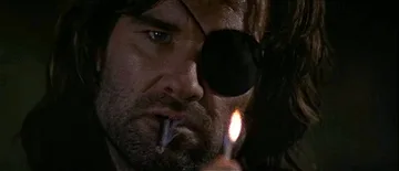A six-panel sequence shows a man with a black eye patch and long hair lighting a cigarette with a match. The first three…