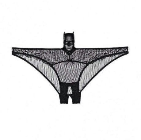 A black lace thong with a Batman mask headpiece is displayed against a plain white background. The garment features a…