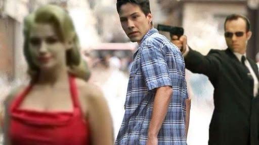 a man in a blue plaid shirt turns to look over his shoulder at a woman in a red dress, while another man in a black suit…