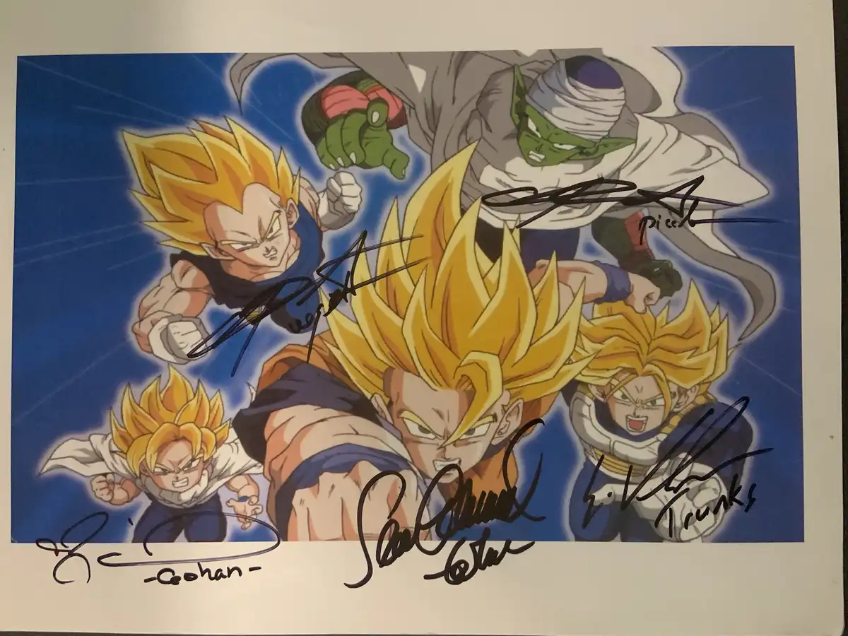 An autographed Dragon Ball Z illustration featuring multiple characters in Super Saiyan forms, including Goku, Vegeta…