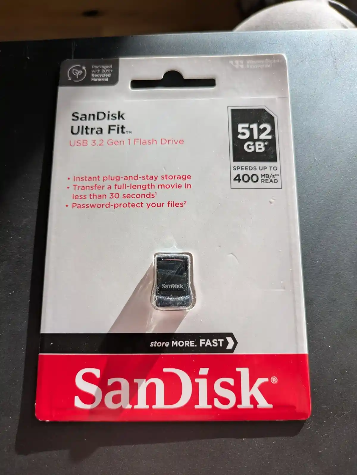 A SanDisk Ultra Fit 512GB USB 3.2 Gen 1 flash drive in its original retail packaging, featuring claims like 'transfer a…