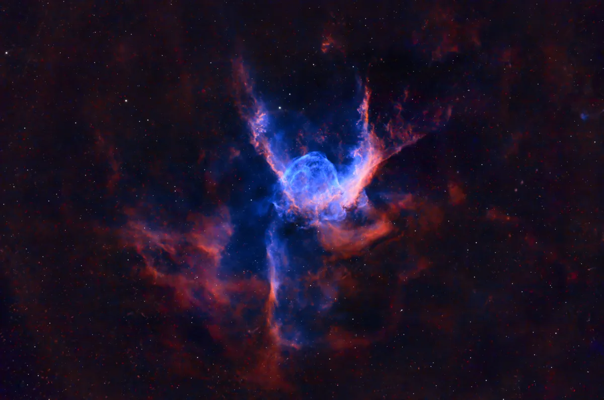 A cosmic nebula with vibrant blue and red clouds against a starry black background, overlaid with the text 'i'm not a fan of…