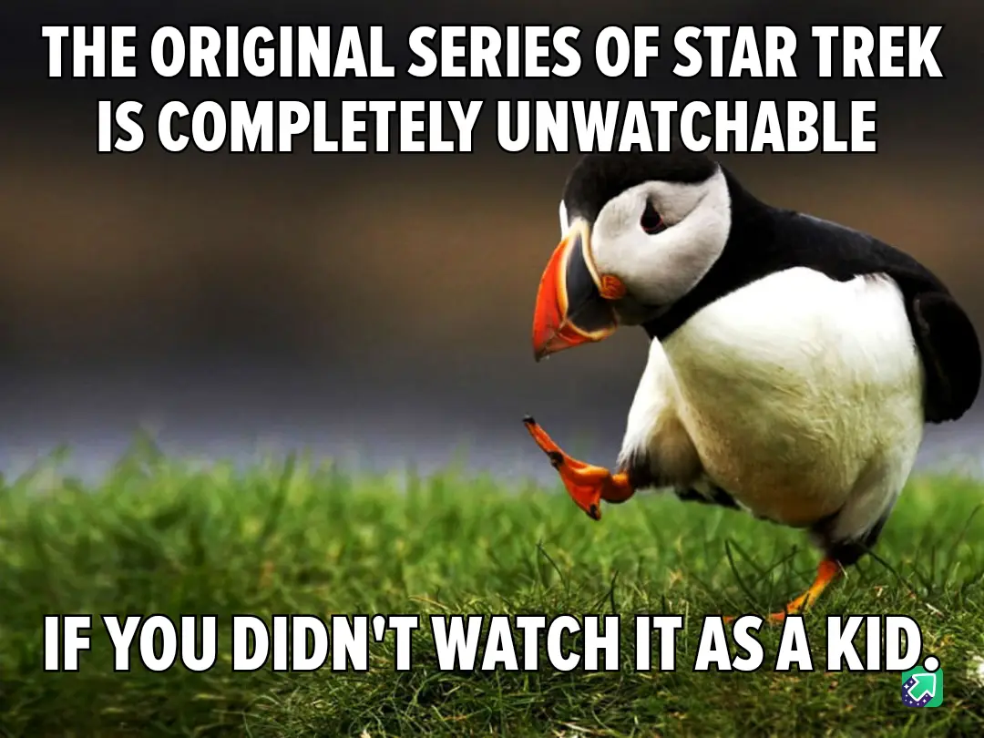 A close-up photo of a puffin standing on green grass, looking down with one foot lifted as if in mid-step. The image has…