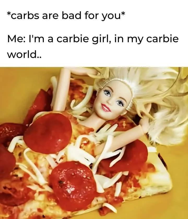 A barbie doll is lying on a slice of pepperoni pizza, surrounded by cheese and toppings, with text above stating '*carbs are…