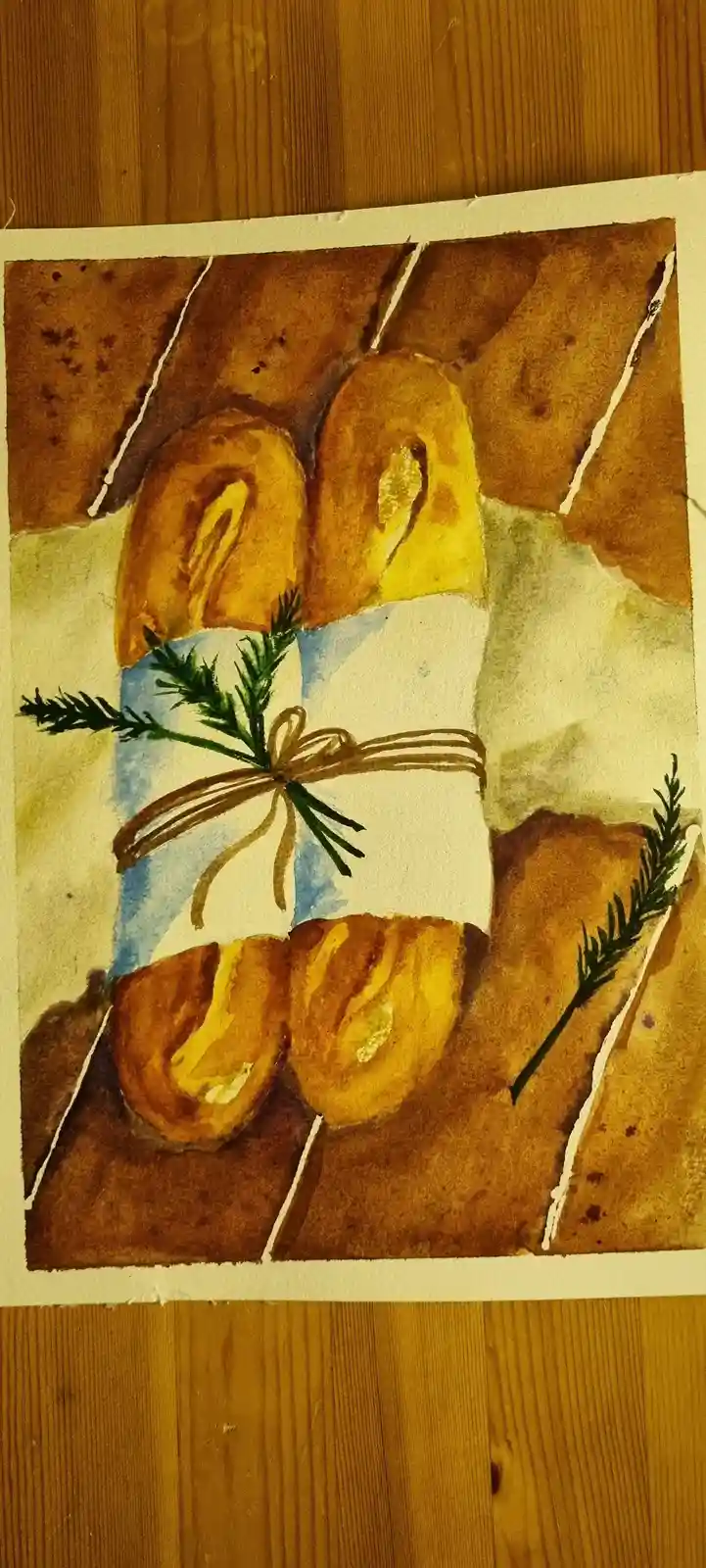 A watercolor painting depicts four golden-brown baguettes arranged around a central bundle of green herbs tied with brown…