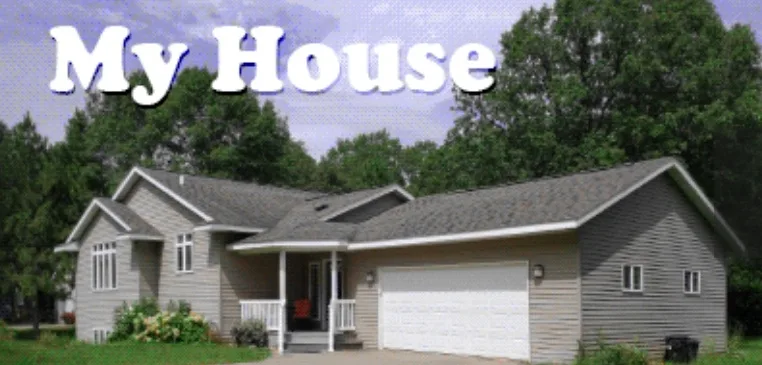 A suburban single-story house with gray siding, a white garage door, and a small front porch, surrounded by green trees and…