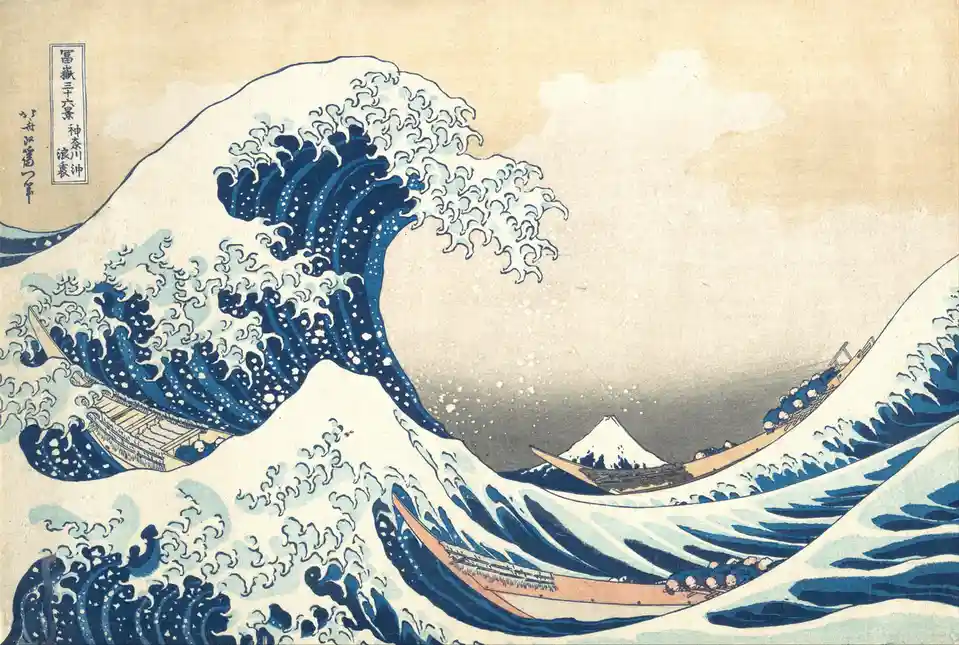 The image is a famous Japanese woodblock print depicting a massive, curling blue wave with white foam, threatening small…