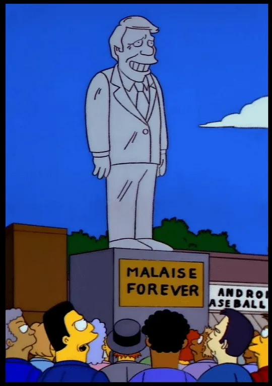 A cartoon statue of a man with a wide, toothy grin stands atop a pedestal labeled 'MALAISE FOREVER' as a crowd of diverse…