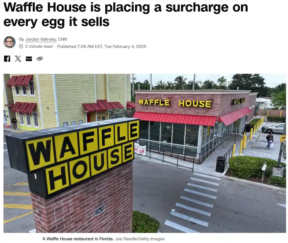 An exterior photo of a Waffle House restaurant with its iconic yellow and black sign on a brick pillar and matching signage…