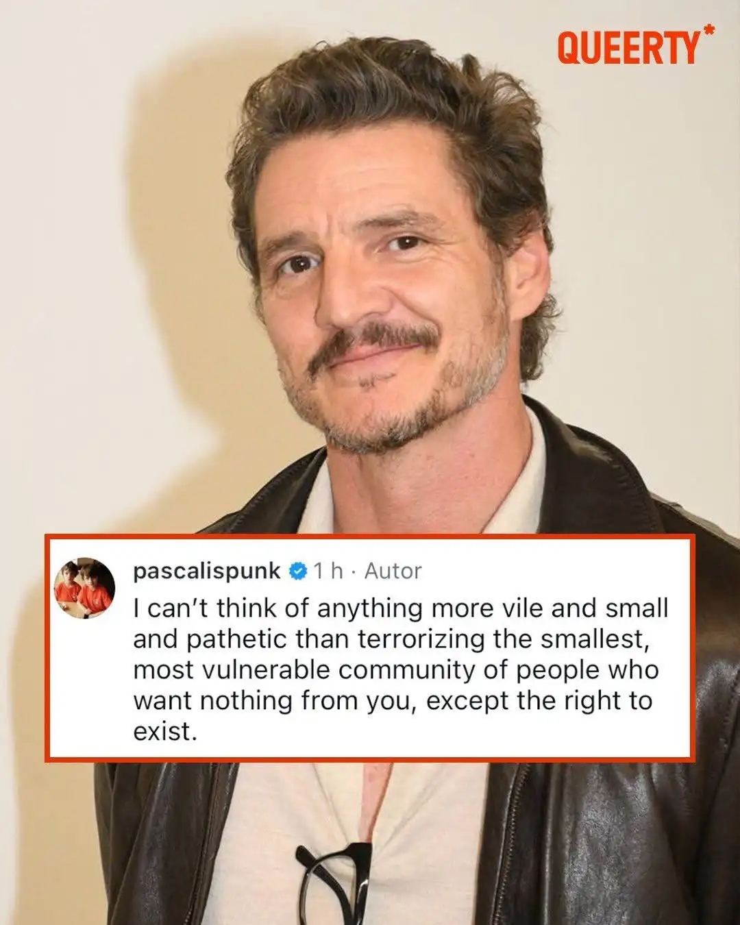 A photo of actor Pedro Pascal smiling while wearing a black leather jacket over a white shirt with glasses hanging from his…