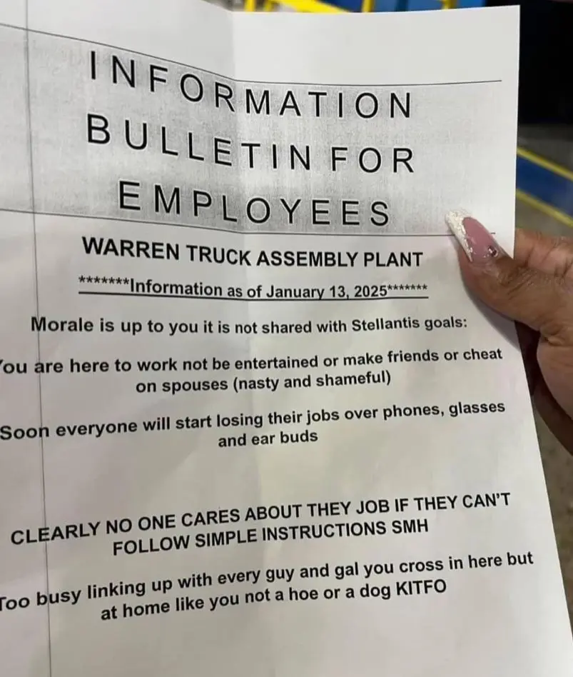 A hand holds a printed 'Information Bulletin for Employees' from the Warren Truck Assembly Plant dated January 13, 2025. The…