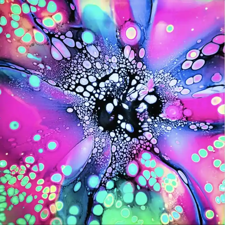 A vibrant abstract image of colorful paint blobs and swirls in pink, purple, blue, and green, resembling a psychedelic…