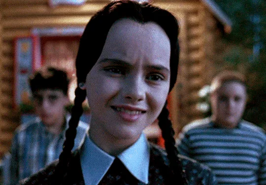The image shows a split-screen of Wednesday Addams from The Addams Family movie, with three frames in the top row and three…