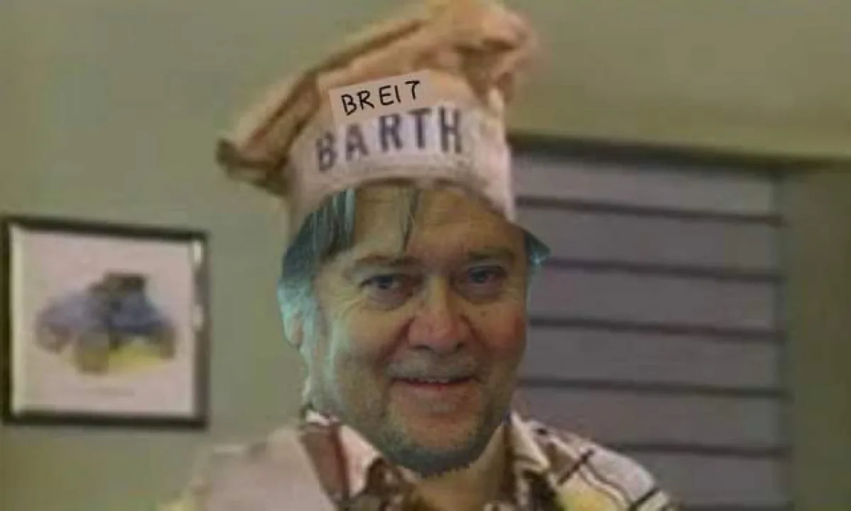 A man with a slight smile wears a chef's hat that has the words 'BREIT' and 'BARTH' written on it in black marker. The…