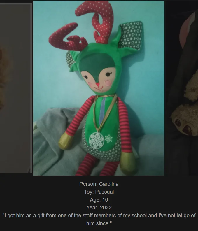 A green plush reindeer toy named Pascal, with red polka-dot antlers and striped red-and-white arms, sits on a gray blanket…