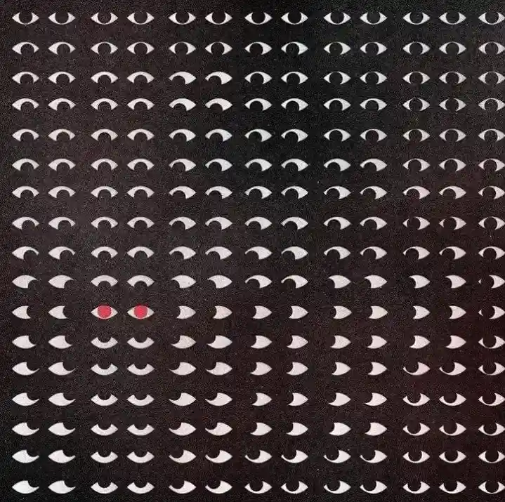 A black background filled with a repeating pattern of white, stylized eyes. One pair of eyes in the lower-left quadrant is…