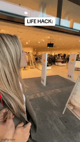 A woman tries on a coat in a clothing store, then walks away with it, only to be shown later with a red balloon floating…
