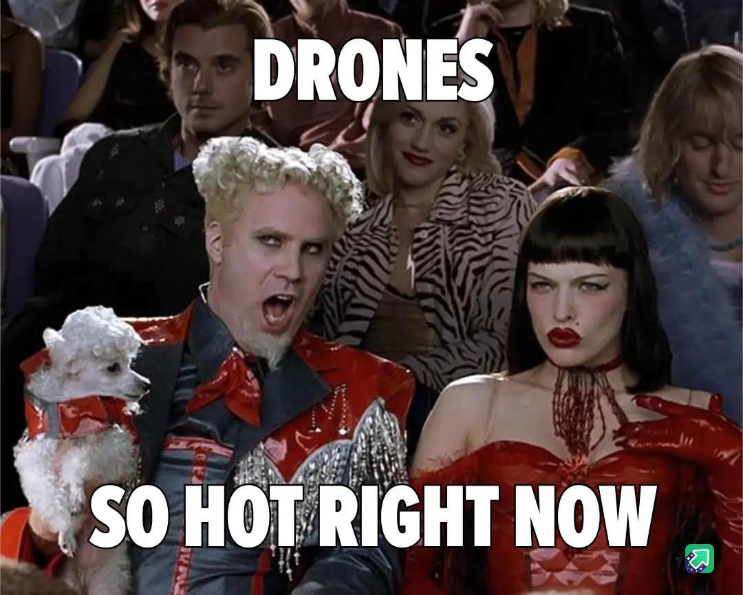 A still from the movie 'The Matrix Reloaded' shows a man with curly blonde hair in a red outfit holding a small white dog…
