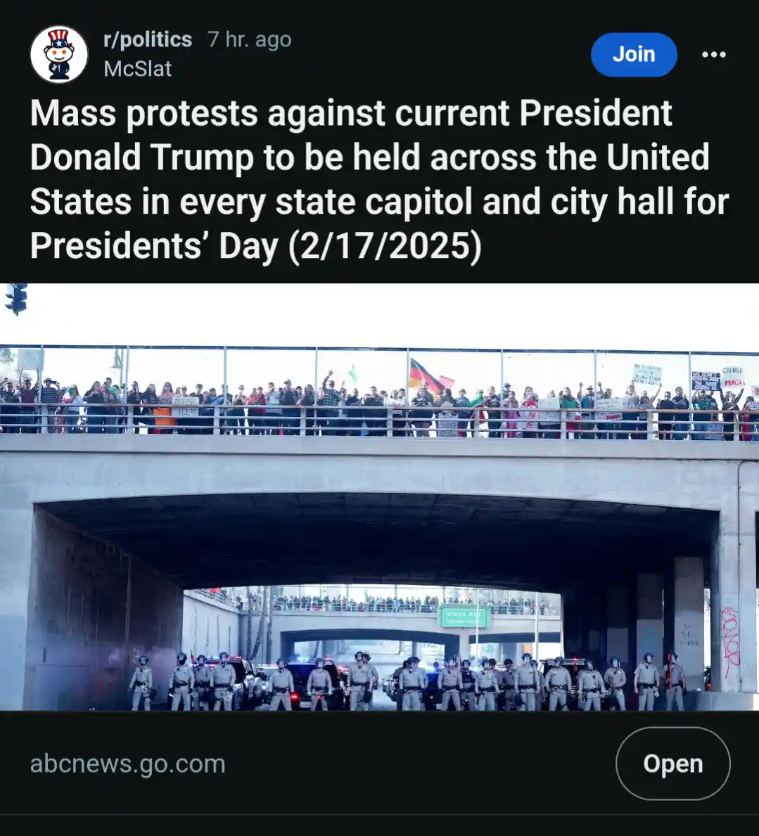 The image shows a screenshot of a Reddit post from r/politics, which features a photo of police officers standing in…