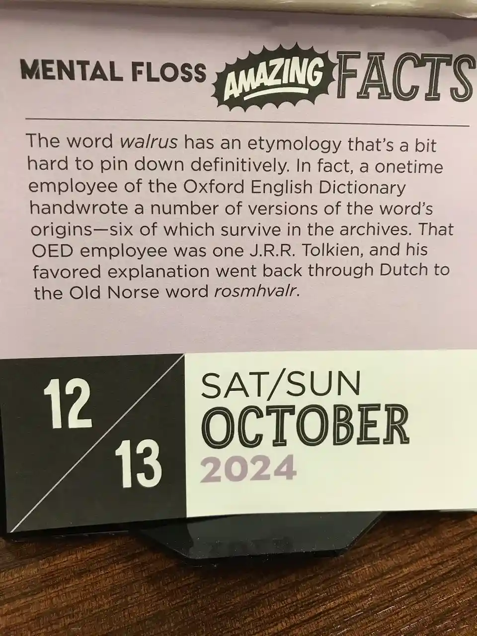 A close-up of a 'Mental Floss Amazing Facts' calendar card for October 12-13, 2024, showing a fact about the etymology of…