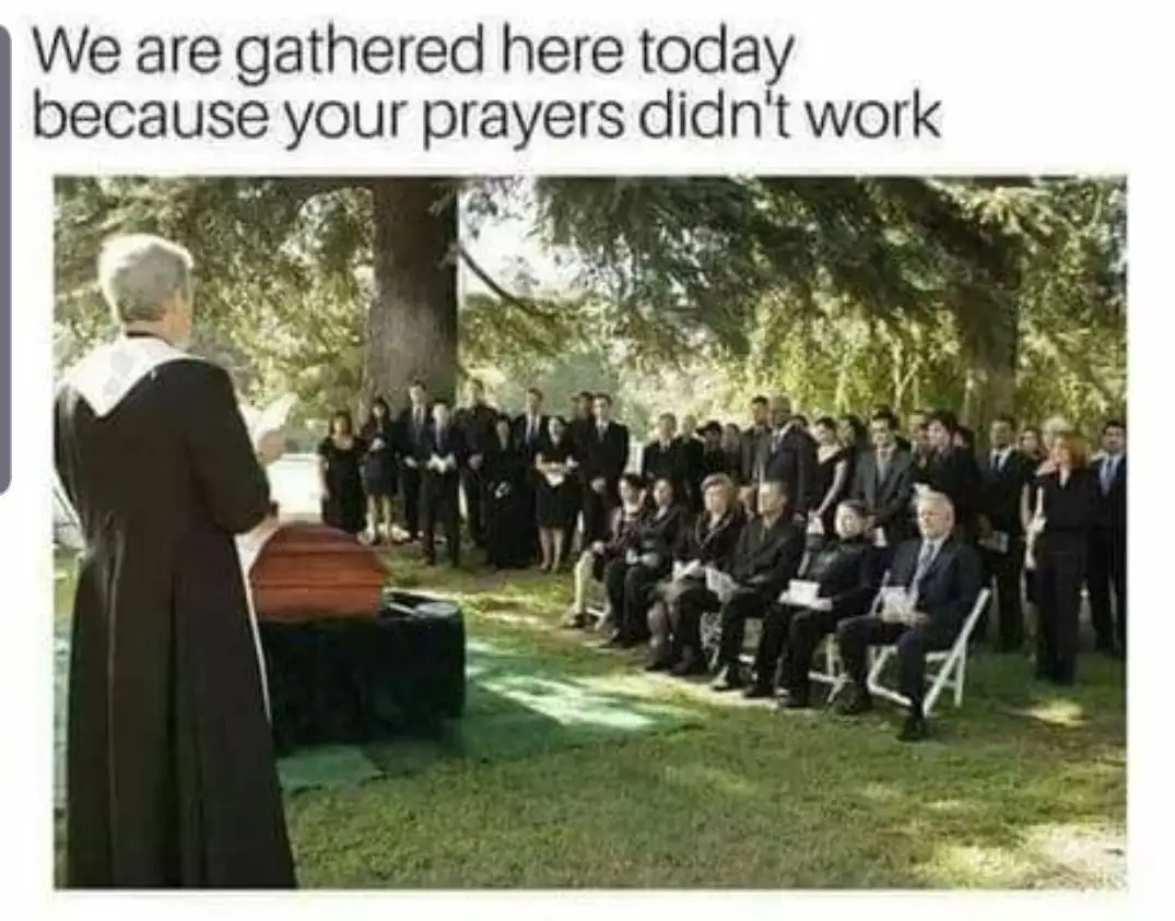 A funeral scene outdoors with a priest in a black robe standing at a coffin, facing a crowd of mourners in black attire…
