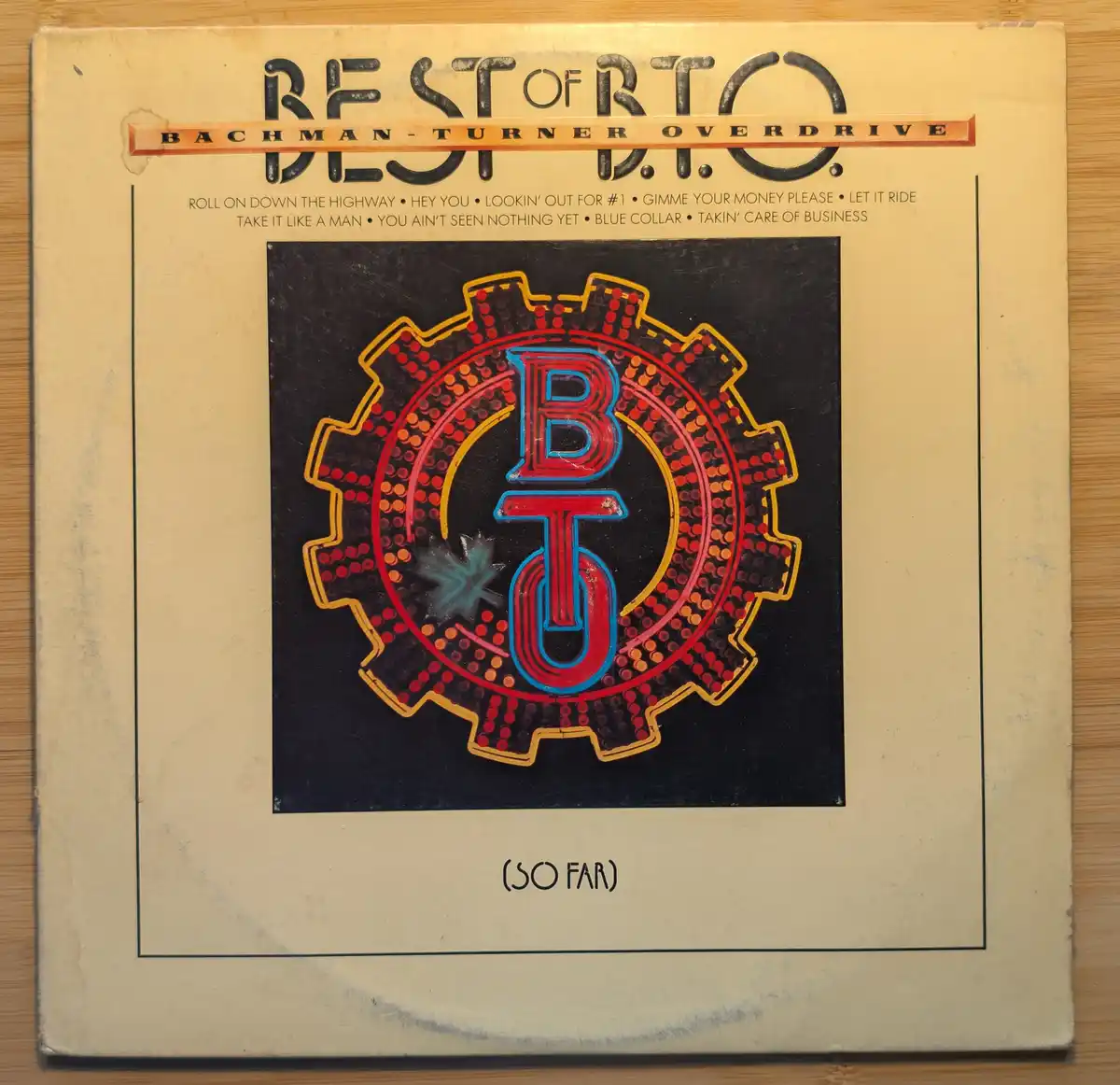 The image shows the cover of the 'Best of B.T.O.' album by Bachman-Turner Overdrive, featuring a large gear logo with the…