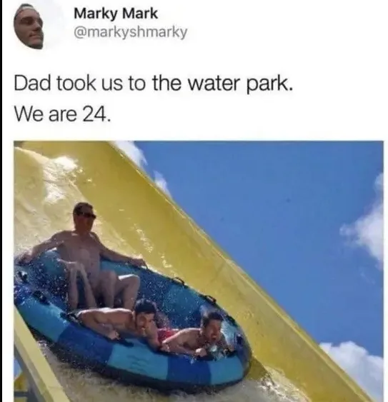 A social media post by Marky Mark shows three adult men in a blue inflatable tube sliding down a yellow water slide at a…