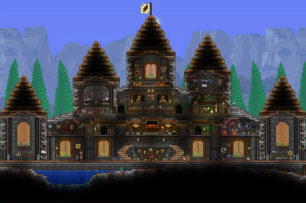 A pixel-art image from the game Terraria shows a massive, multi-story house built with stone and wood, featuring numerous…