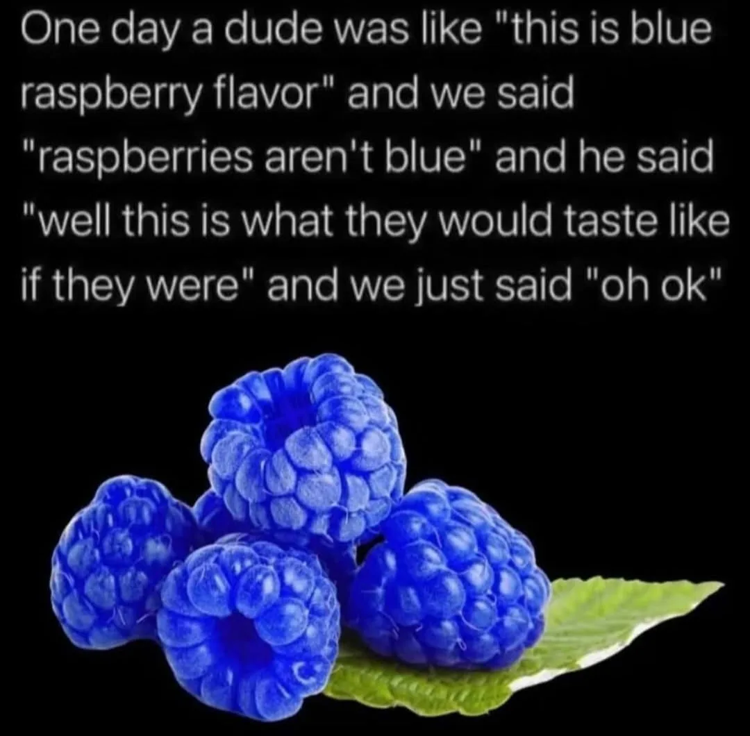 The image shows four vividly blue raspberries resting on a single green leaf against a solid black background. The overlaid…