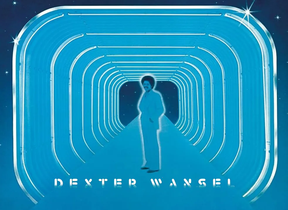 A man in a white suit stands at the end of a glowing blue tunnel with curved metallic walls, set against a starry night sky…