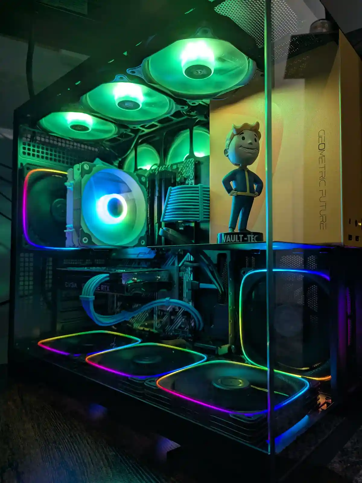 A custom-built PC with a glass case, showcasing RGB-lit fans and components, including a blue-lit CPU cooler and a…