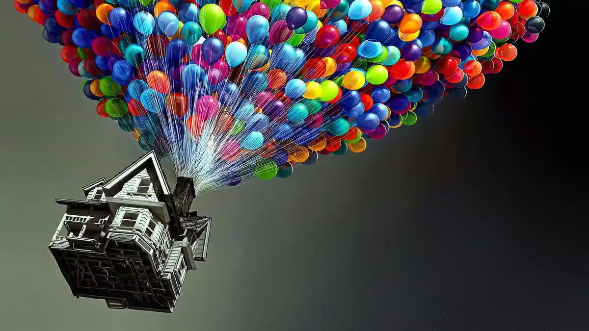 A detailed black-and-white house is suspended in the air, lifted by a massive cluster of colorful balloons in shades of…