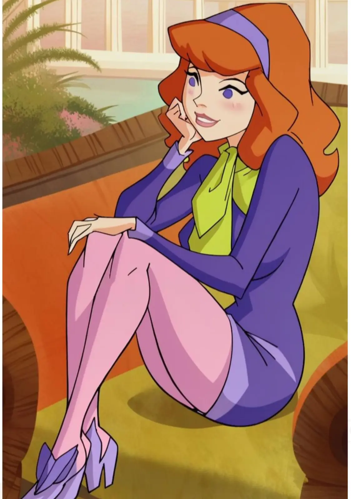 daphne blake from the scooby-doo animated series is shown sitting on a yellow couch in a relaxed pose, wearing her signature…
