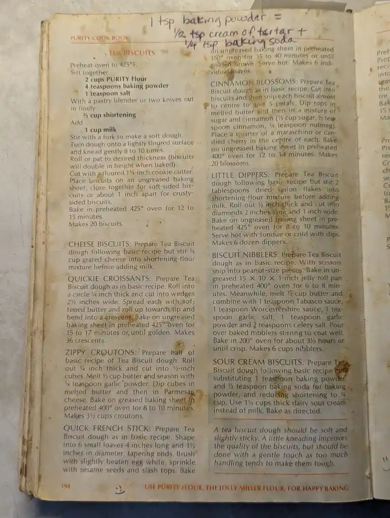 An old, stained page from a 'Purity Cook Book' shows a recipe for 'Tea Biscuits' and several variations. At the top…