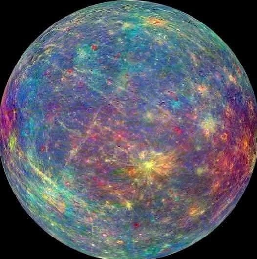 A colorful, false-color image of the planet Mercury, showing its cratered surface with vibrant blues, purples, reds, and…