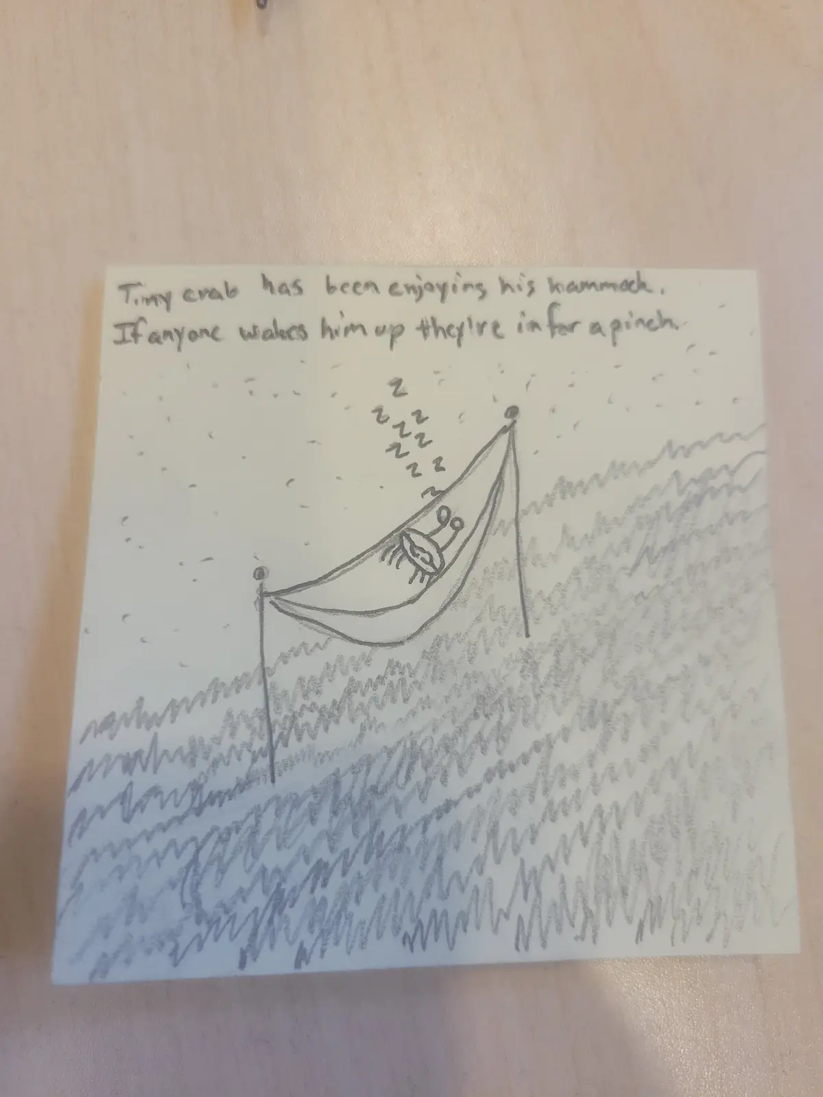 A hand-drawn sketch shows a small crab sleeping peacefully in a hammock strung between two poles, with 'Zzz' sleep symbols…