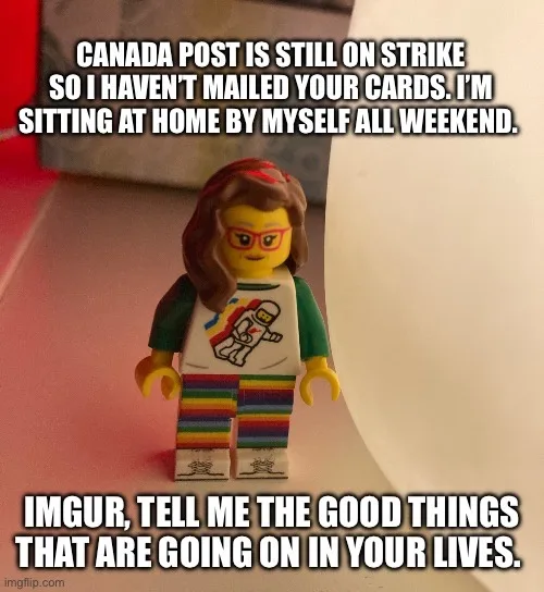 A Lego minifigure with brown hair, red glasses, and a rainbow-striped outfit stands on a surface. The text overlaid on the…