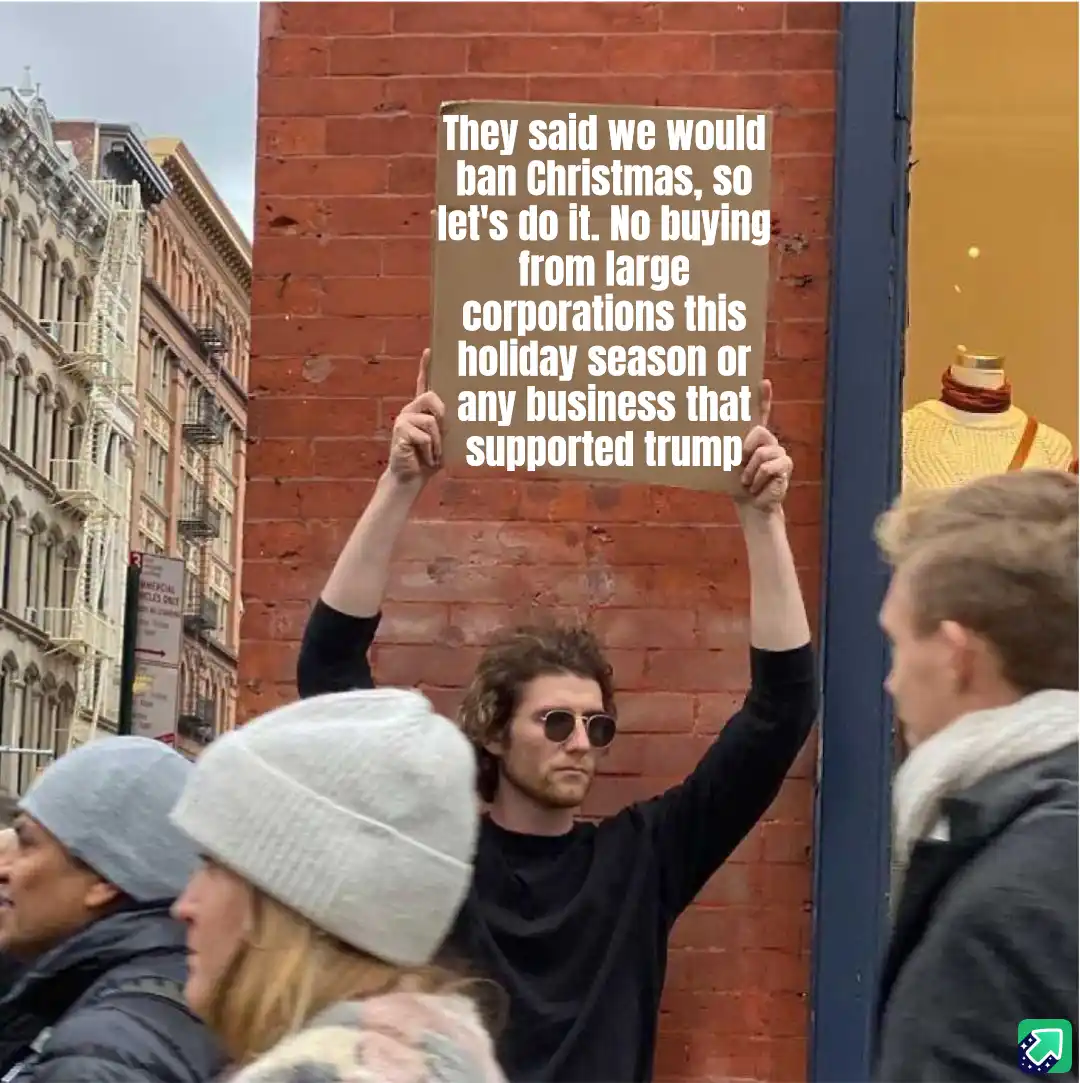A man with curly hair and sunglasses holds up a cardboard sign in a city street with brick buildings. The sign reads: 'They…