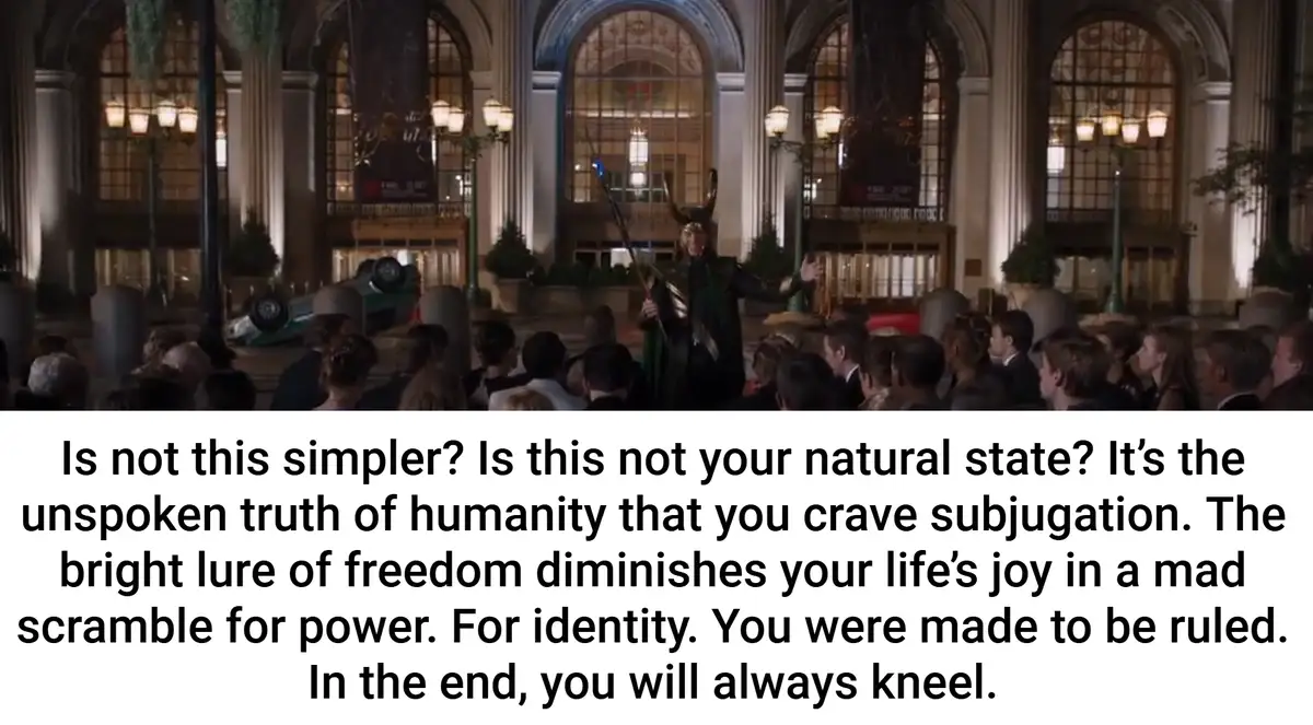 A still from a movie shows Loki, in his green and gold costume with horned helmet, standing in a grand, ornate hall before a…