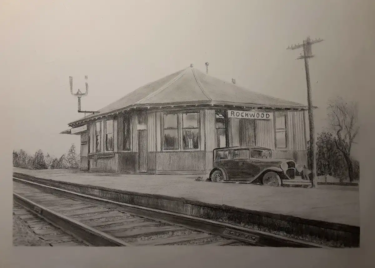 A pencil sketch of a vintage train station labeled 'ROCKWOOD' with a classic 1930s car parked beside it on a platform next…